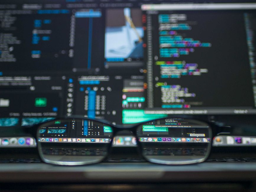 A person looking at a screen with a puzzled expression, surrounded by code and email icons, symbolizing the complexity of ESP API rate limits.