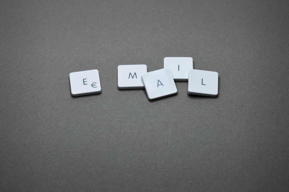 A photo of a person checking their email inbox on a laptop with a mix of opened and unopened emails, symbolizing the perfect balance of email frequency.
