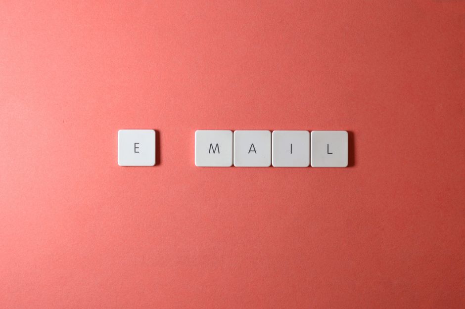 A person sitting in front of a computer with a surprised expression, surrounded by empty email inboxes, symbolizing the challenge of starting email marketing from zero subscribers.