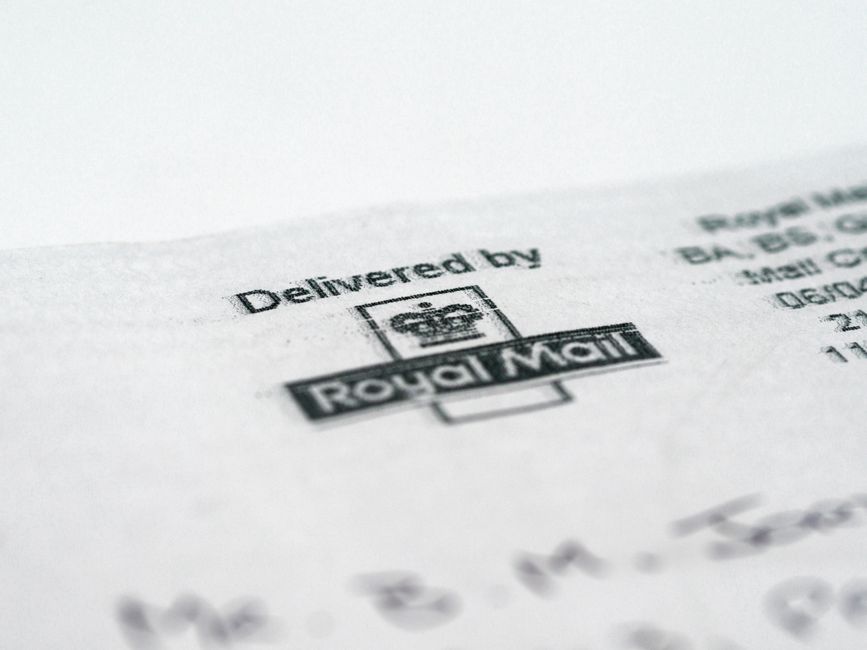 A split-screen image of Postmark and SendGrid logos with a background of email notifications and transactional email metrics.