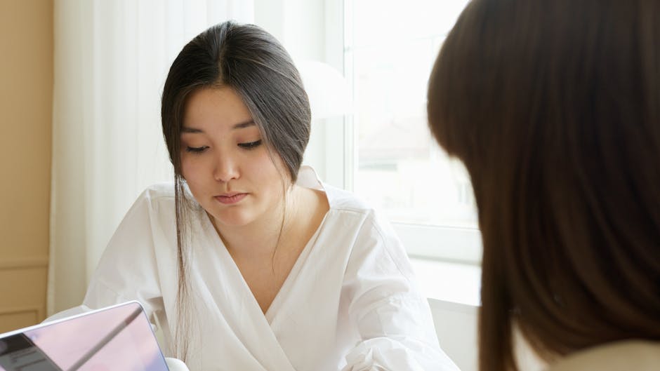 A person looking at their laptop with a thoughtful expression, symbolizing the reevaluation of returning visitor sessions.