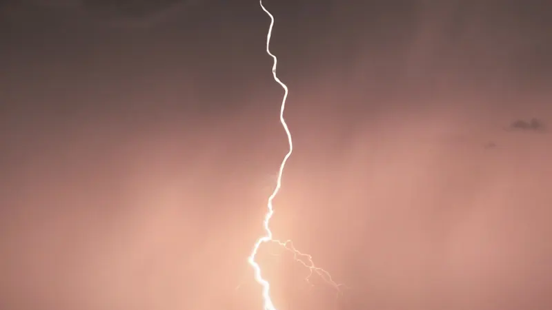 Lightning bolt against an orange sky